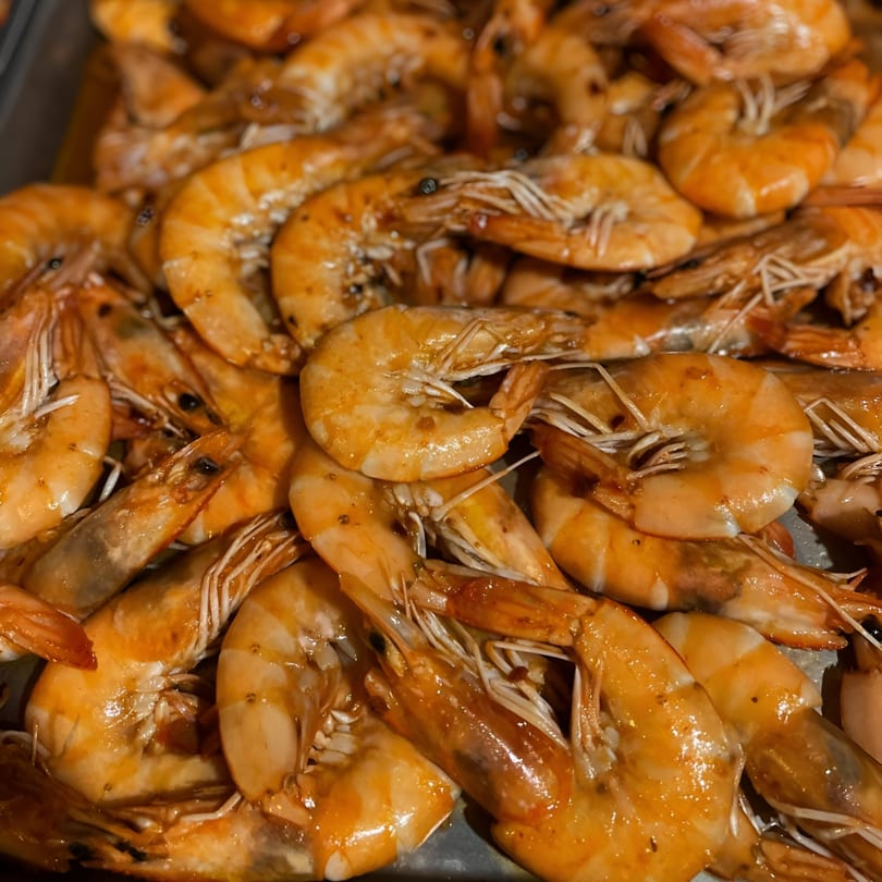Close-up of a large serving of golden-brown cooked shrimp, a Filipino food specialty.
